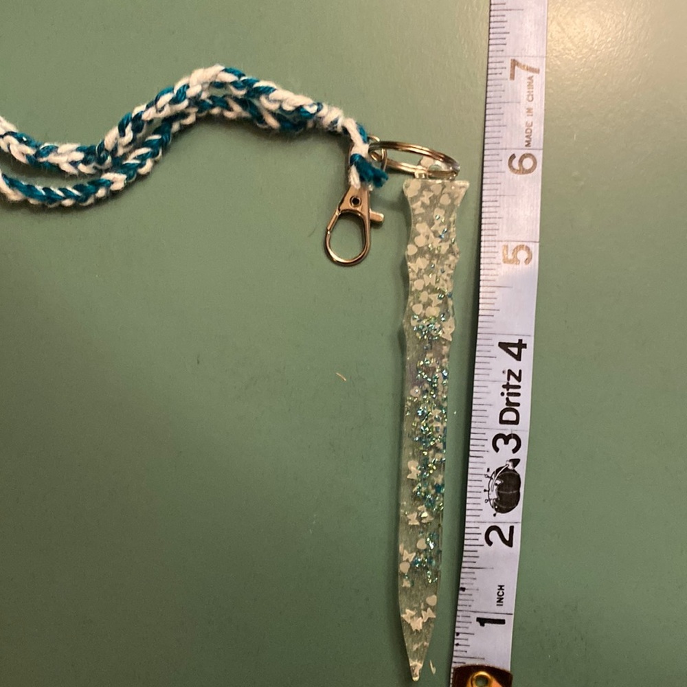 Clear with teal glass stones/glow in the dark pieces self-defense resin keychain